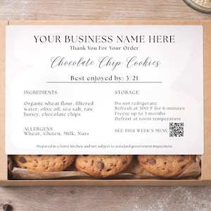 May include: A box of chocolate chip cookies with a label that reads "YOUR BUSINESS NAME HERE" and "Chocolate Chip Cookies". The cookies are visible through a window in the cardboard box. The label also includes the text "Best enjoyed by: 3/21".