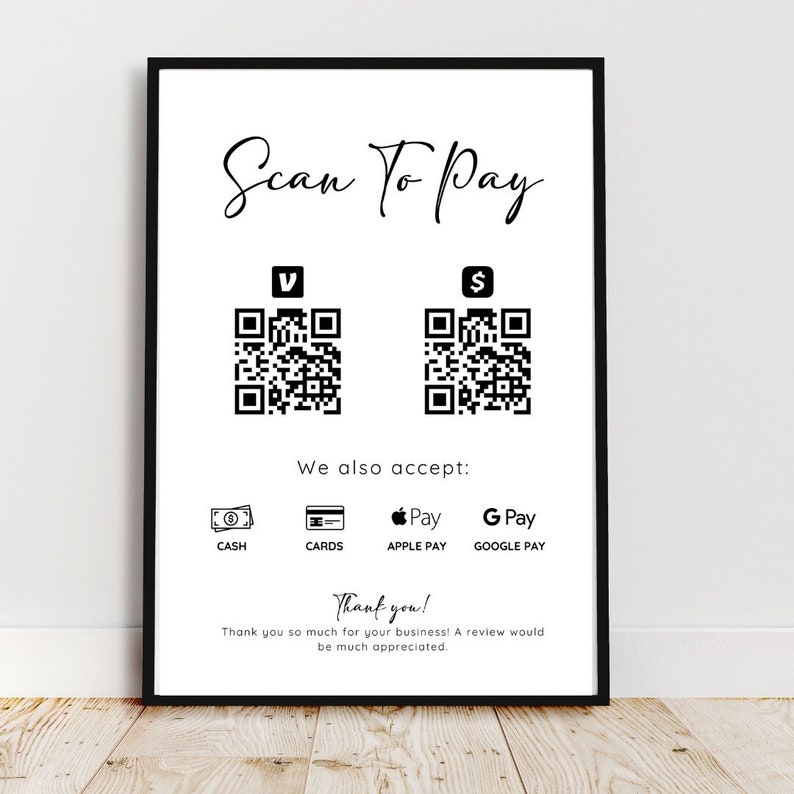 May include: Black and white sign with the text "Scan To Pay" and two QR codes. The sign also lists various payment methods including cash, cards, Apple Pay, and Google Pay. The sign reads "Thank you! Thank you so much for your business! A review would be much appreciated."