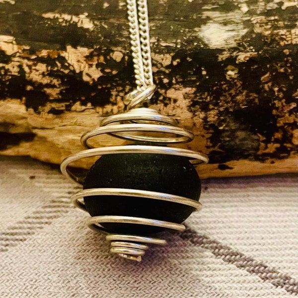 Seaham perfect round pebble in a  round spiral cage pendant on a  27 inch sterling silver chain