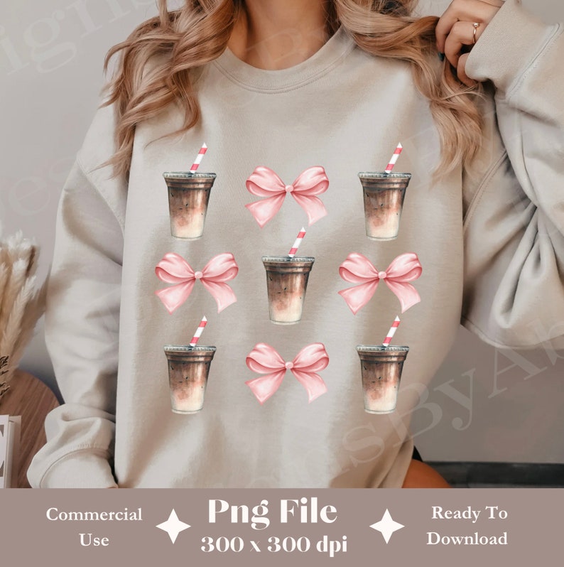 May include: A light grey sweatshirt with a repeating pattern of iced coffee drinks and pink bows. The design is centred on the sweatshirt.