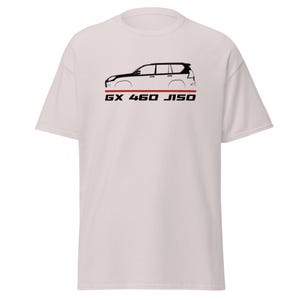 May include: A light-coloured short-sleeve t-shirt featuring a black side-profile graphic of a GX 460 J150 vehicle. Below the car illustration is a thin horizontal red line and the black text GX 460 J150 printed in a bold, sans-serif font.
