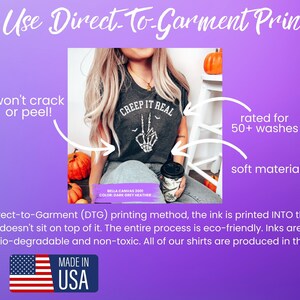 May include: A close-up of a dark grey t-shirt with the text "CREEP IT REAL" printed on it. The shirt is made with a soft material and is rated for 50+ washes. The image also includes a green eco-friendly logo and a Made in USA logo.