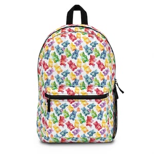 May include: A white backpack with a colorful gummy bear pattern. The bears are in various shades of red, orange, yellow, green, blue, and purple.