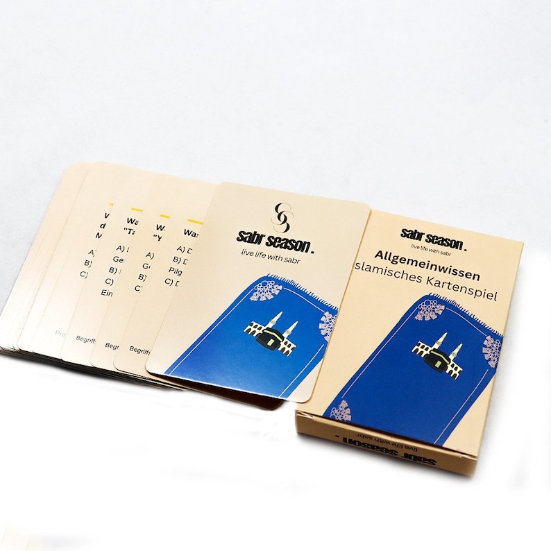 May include: A set of Islamic general knowledge playing cards with a blue background and a gold border. The cards feature a mosque and the text "sabr season. live life with sabr".
