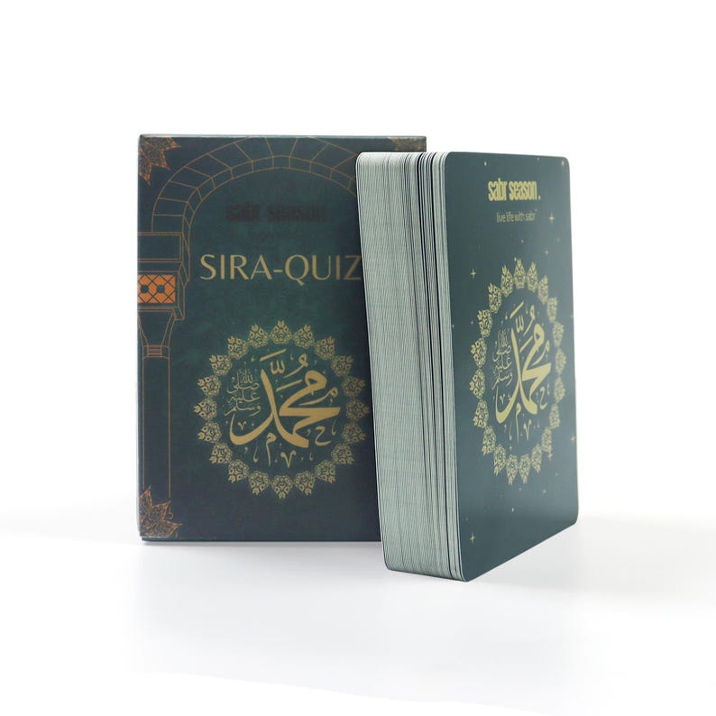 May include: A green box with gold lettering that says "Sira-Quiz" and a gold image of a mosque. The box is next to a stack of green cards with gold lettering that says "sirat season" and a gold image of a mosque.