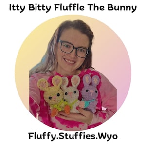 May include: A woman wearing a pink tie-dye shirt is holding three crocheted bunny plushies. The bunnies are yellow, white, and purple. The text "Itty Bitty Fluffle The Bunny" is at the top of the image and the text "Fluffy.Stuffies.Wyo" is at the bottom of the image.