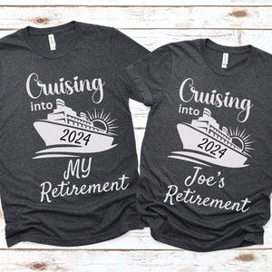 May include: Two dark gray t-shirts with a white cruise ship graphic and the text "Cruising into 2024" on each shirt. One shirt says "My Retirement" and the other says "Joe's Retirement".