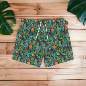 May include: Tropical print swim trunks with a green, blue, yellow, and orange pineapple pattern.