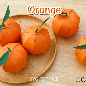 May include: Four paper orange crafts on a wooden surface. The oranges are folded and have green paper leaves. The text "Orange" is in the top center of the image. The text "SVG, PDF FILE" is in the bottom center of the image. The text "F.craft" is in the bottom right corner of the image.