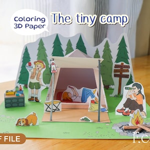 May include: A 3D paper craft scene titled "The tiny camp" with a camping theme. The scene includes a tent, campfire, and figures of people and a dog. The words "Coloring 3D Paper" and "PDF FILE" are also visible.