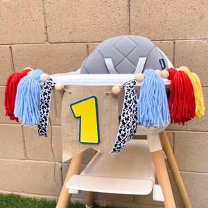 toy cartoon character 1st birthday high chair banner