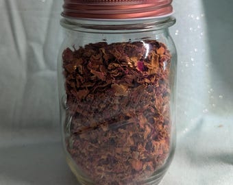 May include: A glass jar with a copper lid filled with dried rose petals.