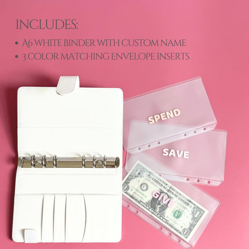 May include: White A6 binder with a custom name, open to reveal a silver ring binder and interior pockets. Includes three transparent envelope inserts labeled "SPEND", "SAVE", and "GIVE", with a dollar bill visible in the "GIVE" envelope.