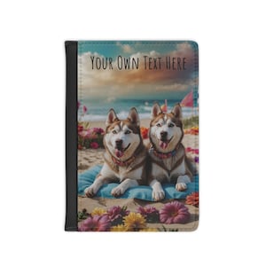 May include: A black passport holder featuring a beach scene with two Siberian huskies. The text "YOUR OWN TEXT HERE" is printed at the top. The dogs are lying on a blue cushion surrounded by flowers.