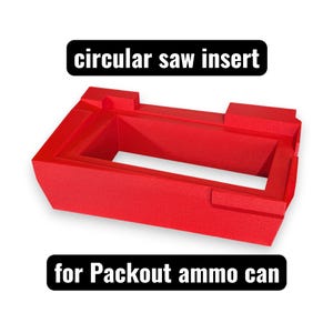 May include: A bright red, rectangular plastic insert for a circular saw, designed for a Packout ammo can. The object features a hollow center and molded edges. Text above reads circular saw insert and text below reads for Packout ammo can.