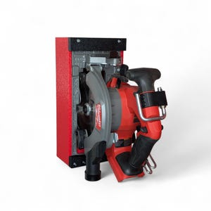 May include: A red and black wall-mounted power tool holder with a red and gray circular saw. The saw is a Milwaukee brand. The holder is mounted on a white background.