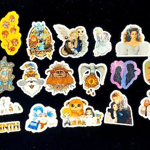 May include: A collection of colorful stickers featuring characters and scenes from the movie "Labyrinth." The stickers showcase various characters, including goblins, the owl, and the main cast, with vibrant colors and detailed designs.