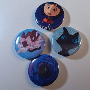 May include: Four round buttons with images from the animated film "Coraline." One button features a girl with the name "Coraline" below. Other buttons show a pink house, a black cat with blue eyes, and a blue tunnel.