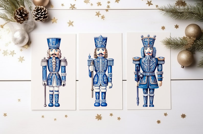 May include: Three blue and white nutcracker figurines with gold accents. The nutcrackers are standing in a row on a white background.