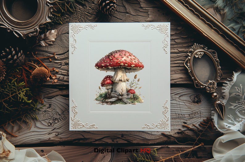 May include: A white card with an ornate border features a watercolor illustration of a red and white mushroom with white spots. The mushroom is surrounded by green foliage and a blue ribbon.