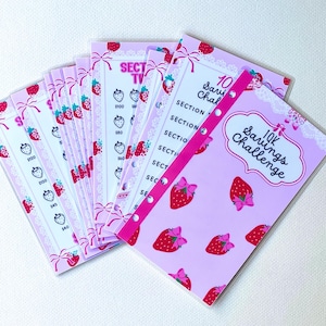 May include: A pink and white savings challenge tracker with a strawberry theme. The tracker has 10 sections and includes the text "10K Savings Challenge".