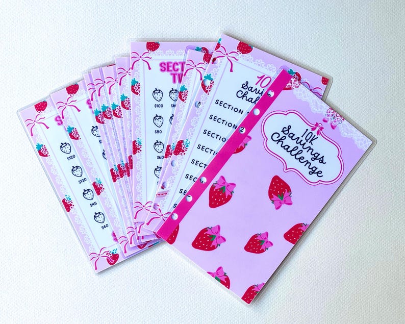 May include: A pink and white savings challenge tracker with a strawberry theme. The tracker has 10 sections and includes the text "10K Savings Challenge".