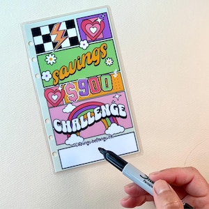 May include: A colorful printable planner page with a savings challenge theme. The page features a rainbow, hearts, stars, and the text "savings $900 challenge".