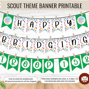 May include: Printable scout-themed banner with green, white and colourful flags. The flags have the words "Happy Bridging Troop 158" on them. The banner is decorated with colourful flower-shaped designs.