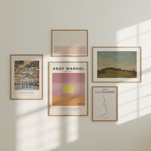 May include: A gallery wall featuring five framed prints. The prints showcase a range of styles, including abstract, landscape, and figurative art. The prints are all in different sizes and colours, and they are arranged in a visually pleasing way.