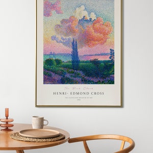 May include: A framed poster of a painting titled "The Pink Cloud" by Henri-Edmond Cross. The painting depicts a landscape with a pink cloud in the sky, trees, and a body of water. The poster includes the title of the painting, the artist's name, and the Cleveland Museum of Art.
