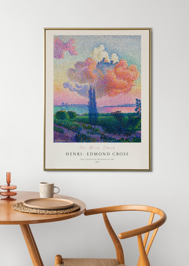 May include: A framed poster of a painting titled "The Pink Cloud" by Henri-Edmond Cross. The painting depicts a landscape with a pink cloud in the sky, trees, and a body of water. The poster includes the title of the painting, the artist's name, and the Cleveland Museum of Art.