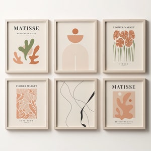 May include: Six minimalist art prints in beige frames with abstract designs in shades of brown, green, and black. The prints feature text such as "Matisse" and "Flower Market".