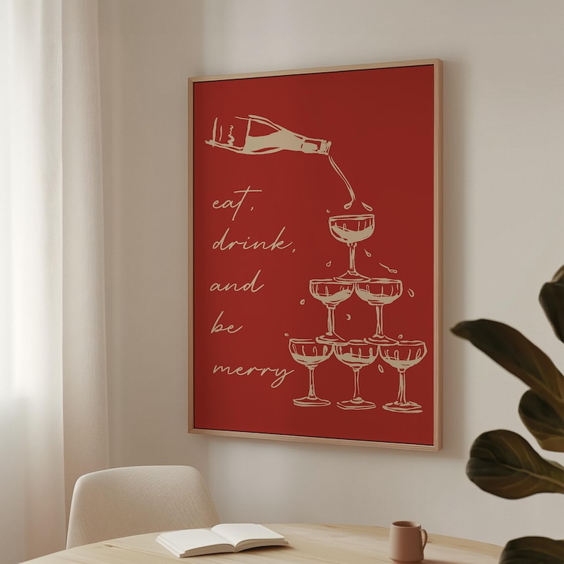 K&ouml;nnte beinhalten: Ein roter Hintergrund mit einer wei&szlig;en Umrandung einer Champagnerflasche, die in einen Stapel Champagnergl&auml;ser gegossen wird. Der Text "eat, drink, and be merry" ist in Wei&szlig; geschrieben.