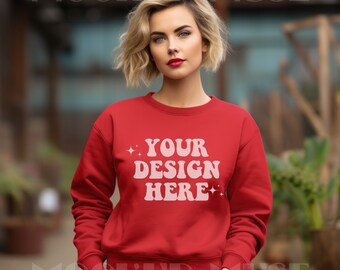 May include: A red sweatshirt with the text "YOUR DESIGN HERE" in a retro font. The sweatshirt is being worn by a person with short blonde hair.