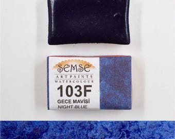 May include: A watercolour paint pan in a blue hue labelled "103F GECE MAVISI NIGHT BLUE" by Semse Art Paints.