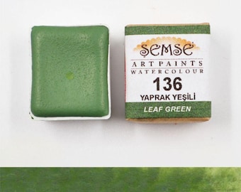 May include: A watercolor paint pan in a green color with the label "Semse Art Paints Watercolour 136 Yaprak Yesili Leaf Green".