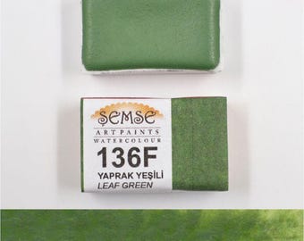 May include: A watercolor paint pan in a green color with the label "Semse Art Paints Watercolour 136F Yaprak Yeşili Leaf Green".