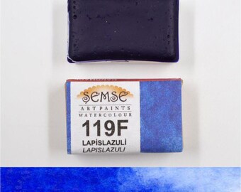 May include: A watercolour paint pan in a blue and red box. The box has the text "Semse Art Paints Watercolour 119F Lapis Lazuli Lapis Lazuli" on it. The paint pan is a dark blue colour.