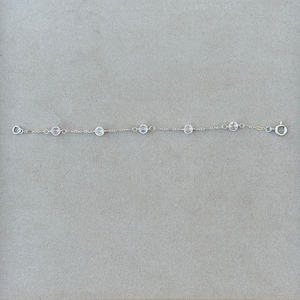 May include: A silver chain bracelet with clear crystal beads.