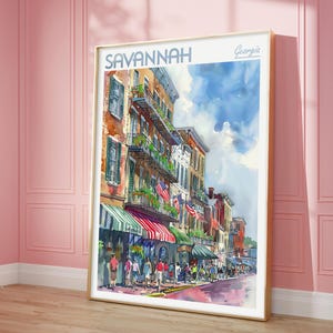 May include: A watercolor painting of a street scene in Savannah, Georgia. The painting depicts a street lined with colorful buildings, with a blue sky and white clouds in the background. The street is filled with people walking and shopping.