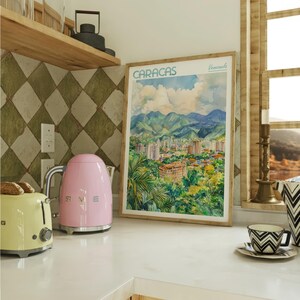 a kitchen counter with a pink toaster and a picture of a city