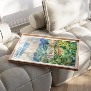 a picture frame sitting on a couch with a painting on it