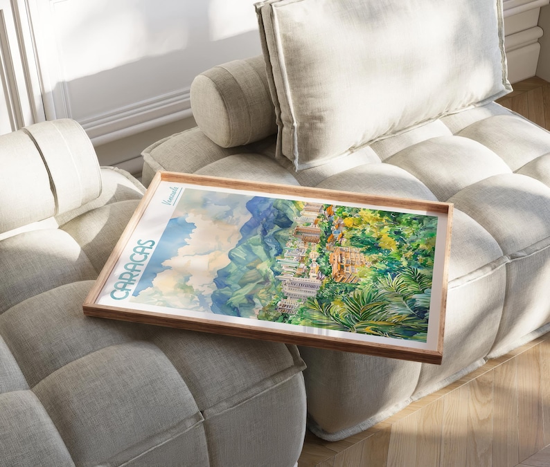 a picture frame sitting on a couch with a painting on it