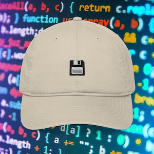 May include: A beige baseball cap with a black and white floppy disk icon embroidered on the front. The background features a blurred image of computer code in shades of blue and green.