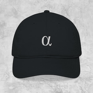 May include: Black baseball cap with a curved brim. The cap features a white embroidered Greek letter alpha on the front. The hat is made of a soft material and has an adjustable strap.