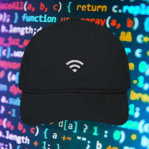 May include: A black baseball cap with a white embroidered Wi-Fi symbol on the front. The cap has a curved brim and a structured design. The background features a blurred image of computer code.