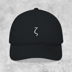 May include: Black baseball cap with a curved brim. The cap features a white embroidered Greek letter zeta on the front. The hat is made of a soft material and has an adjustable strap.