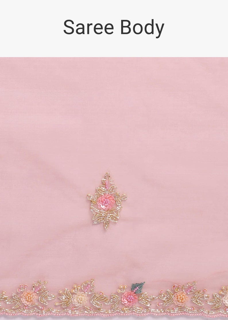 May include: A light pink fabric labeled Saree Body featuring a central floral motif and a bottom border. The embroidery consists of small pink and peach sequins, beads, and metallic gold thread forming delicate flower and leaf patterns.