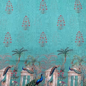 May include: A turquoise fabric featuring a repeating pattern of small red floral sprigs. The lower section displays a detailed scene with peacocks perched on stone pillars, palm trees, and architectural elements, framed by a dark patterned border.