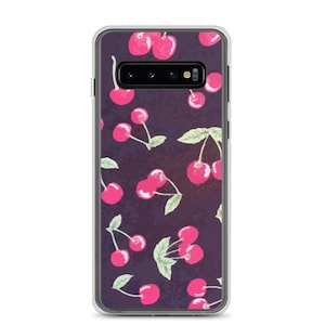 May include: A clear phone case featuring a pattern of pink cherries with green leaves on a dark purple background. The phone case has a clear border and a camera cutout.